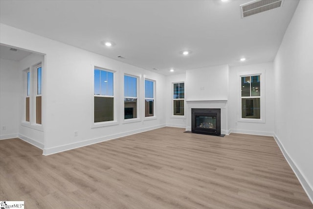 unfurnished living room featuring light hardwood / wood-style floors