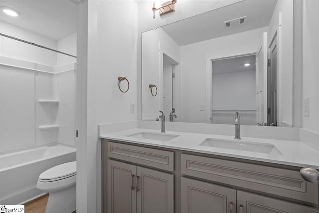 full bathroom with vanity, toilet, shower / tub combination, and wood-type flooring