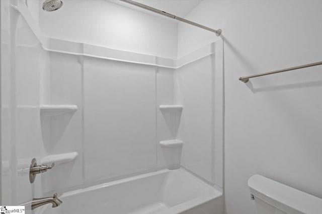 bathroom featuring shower / bathing tub combination and toilet