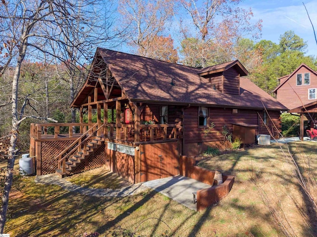 exterior space with central AC and a wooden deck