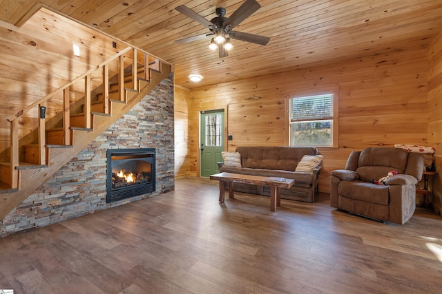 living room featuring hardwood / wood-style flooring, ceiling fan, wooden ceiling, and wood walls