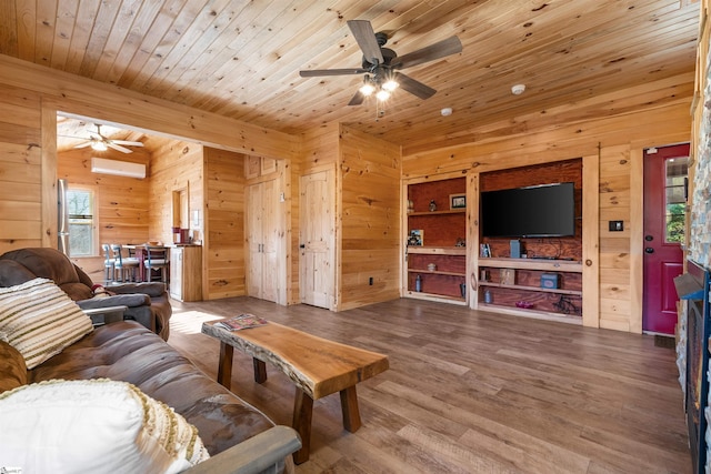 living room with wood walls, wood-type flooring, a wealth of natural light, and an AC wall unit