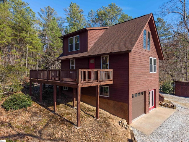 view of front facade with a wooden deck and a garage