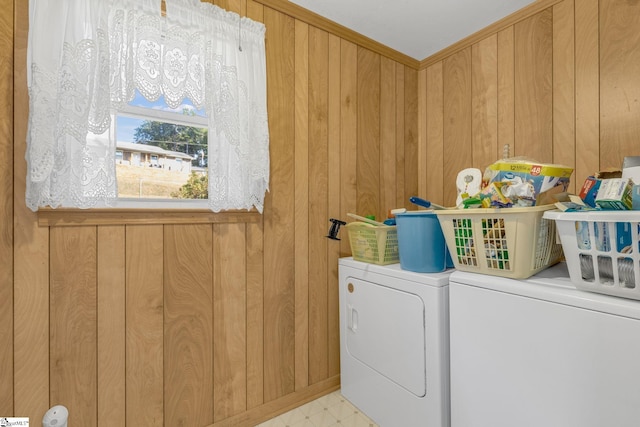 laundry area featuring separate washer and dryer and wooden walls