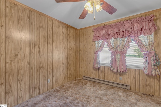 empty room with carpet flooring, vaulted ceiling, ceiling fan, wooden walls, and a baseboard radiator