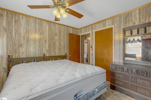 carpeted bedroom featuring ceiling fan, crown molding, and wooden walls