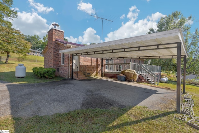 view of parking with a lawn and a carport