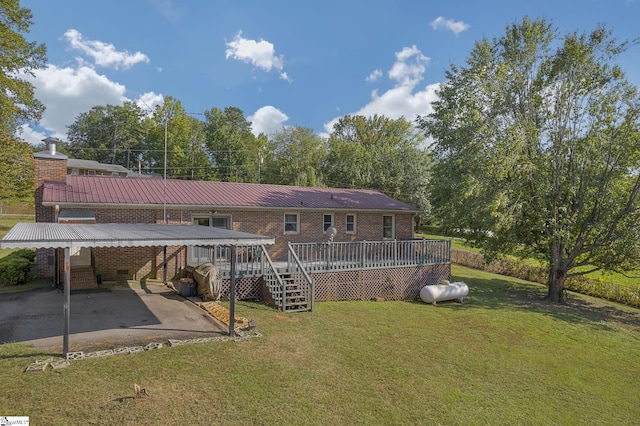 back of property featuring a lawn, a patio area, and a wooden deck