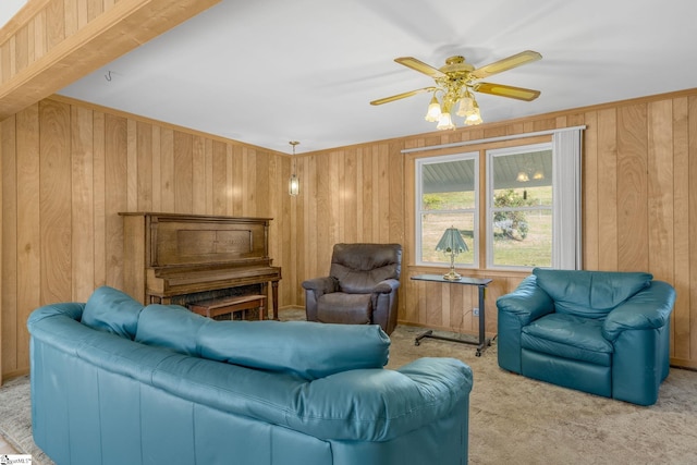 living room with light colored carpet, ceiling fan, and wooden walls