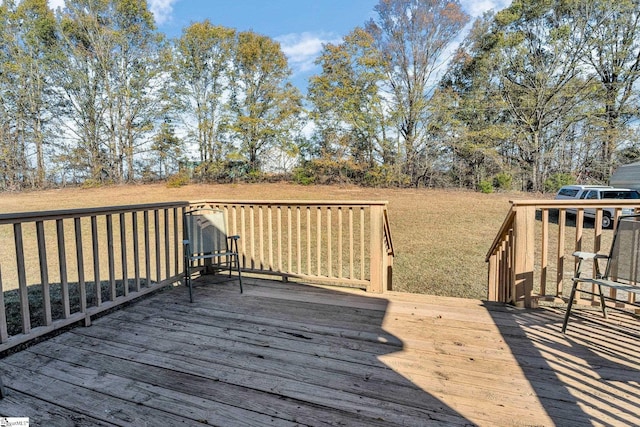 wooden deck with a lawn