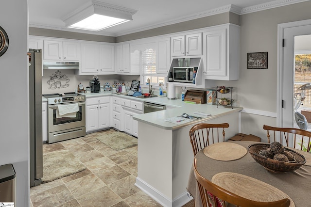 kitchen with sink, kitchen peninsula, crown molding, white cabinets, and appliances with stainless steel finishes