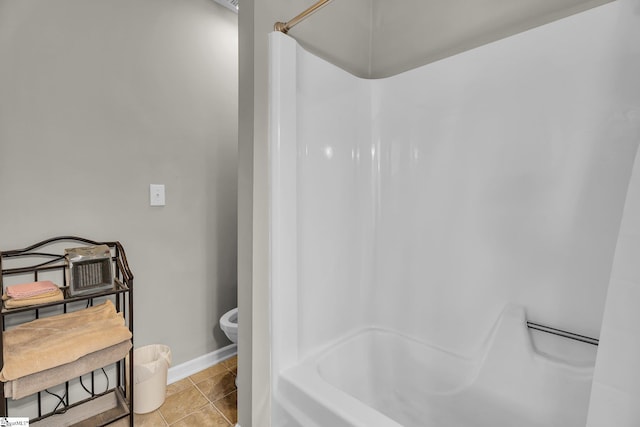 bathroom featuring toilet, bathing tub / shower combination, and tile patterned floors