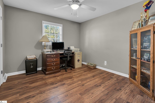 home office with dark hardwood / wood-style floors and ceiling fan