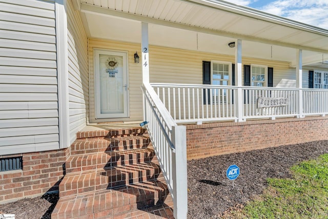 doorway to property with covered porch