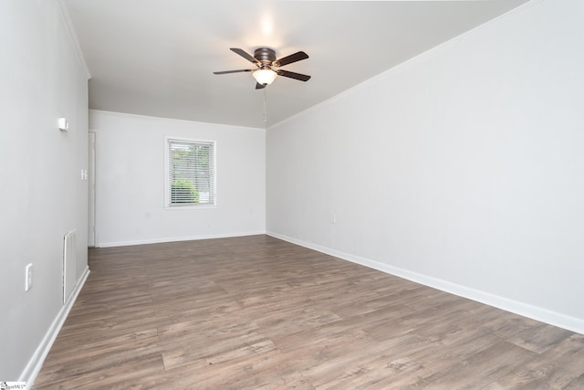 spare room featuring crown molding, ceiling fan, and wood-type flooring