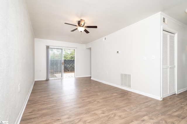 spare room featuring ceiling fan, light hardwood / wood-style floors, and ornamental molding