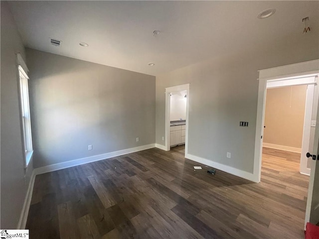 empty room featuring dark wood-type flooring