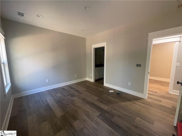 spare room with dark wood-type flooring