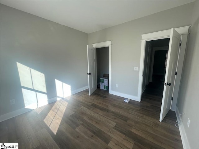 unfurnished bedroom featuring dark wood-type flooring