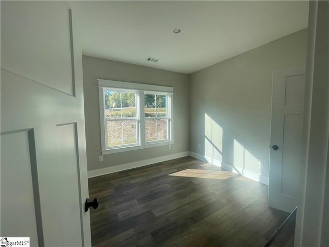 unfurnished room featuring dark hardwood / wood-style floors