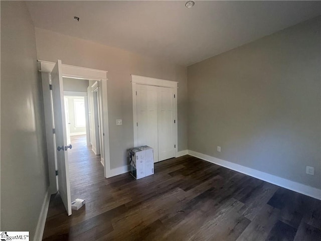 unfurnished bedroom with dark hardwood / wood-style floors