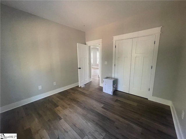 unfurnished bedroom featuring dark hardwood / wood-style floors