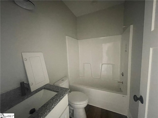 full bathroom featuring shower / tub combination, vanity, wood-type flooring, and toilet