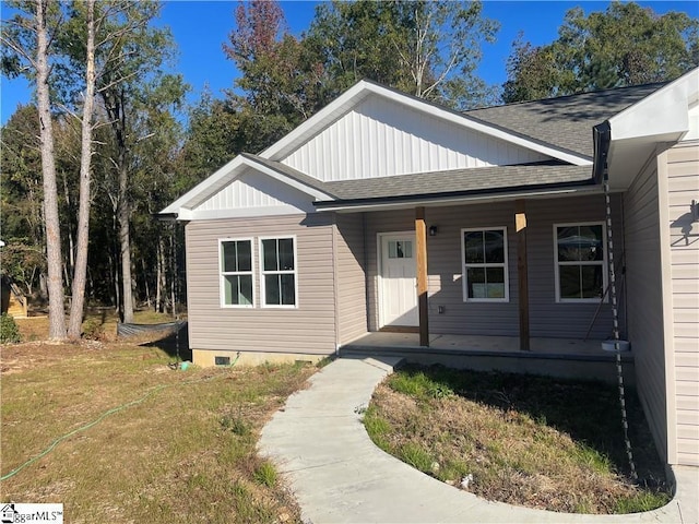 view of front of home with a porch and a front yard