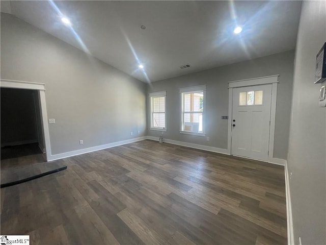 entrance foyer featuring dark hardwood / wood-style flooring and vaulted ceiling