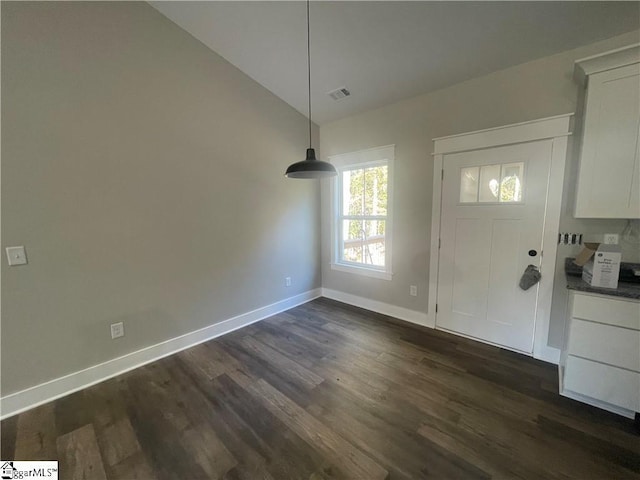 foyer with dark hardwood / wood-style flooring and vaulted ceiling