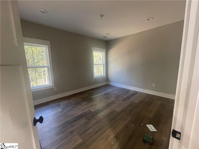 spare room featuring dark hardwood / wood-style floors