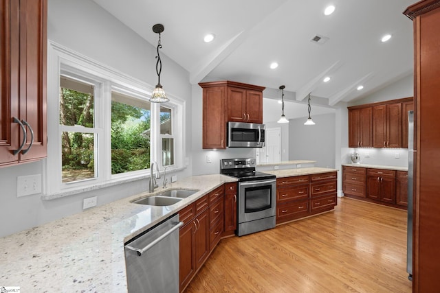 kitchen featuring lofted ceiling with beams, hanging light fixtures, stainless steel appliances, and sink