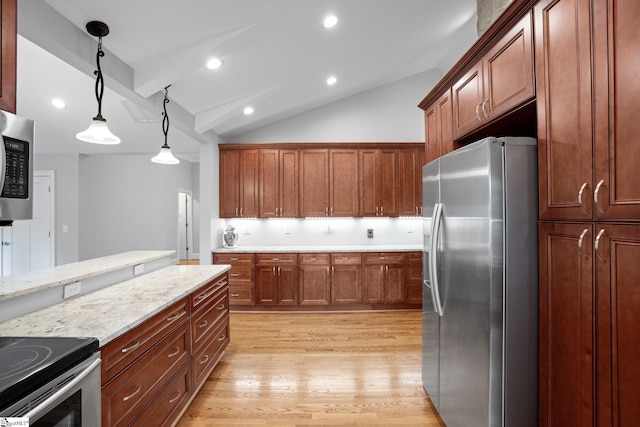 kitchen with light stone countertops, appliances with stainless steel finishes, pendant lighting, light hardwood / wood-style flooring, and vaulted ceiling with beams