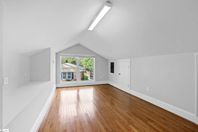 bonus room with hardwood / wood-style floors and lofted ceiling