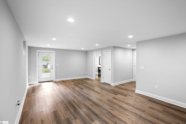 unfurnished living room with dark hardwood / wood-style floors