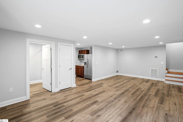 unfurnished living room featuring hardwood / wood-style flooring