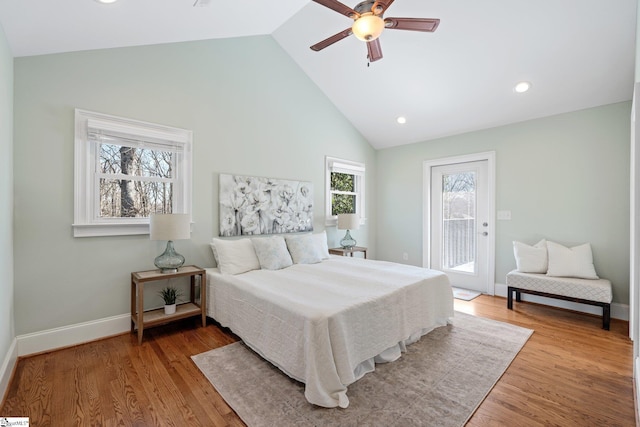 bedroom featuring hardwood / wood-style flooring, high vaulted ceiling, access to outside, and ceiling fan