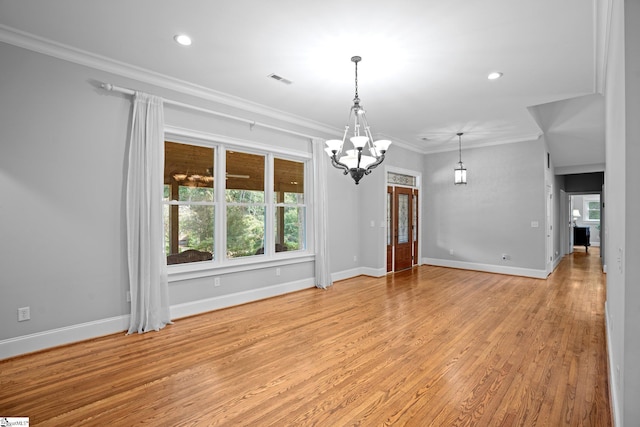 interior space with crown molding, light hardwood / wood-style flooring, and an inviting chandelier