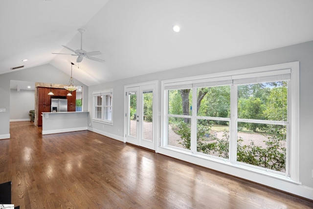 unfurnished living room featuring dark hardwood / wood-style flooring, a wealth of natural light, lofted ceiling, and ceiling fan