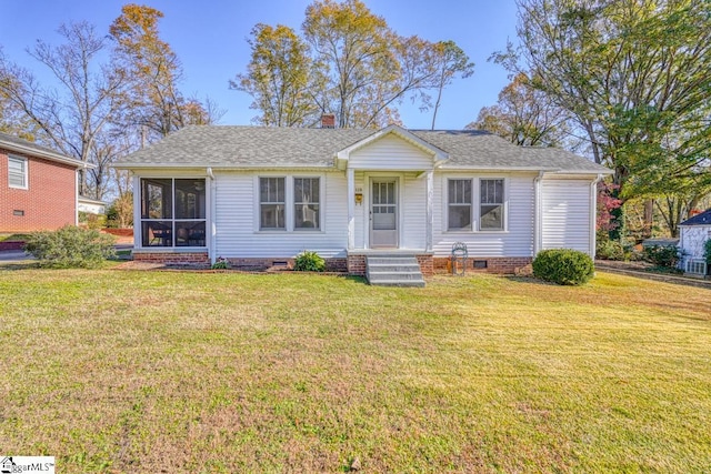 single story home featuring a sunroom and a front yard