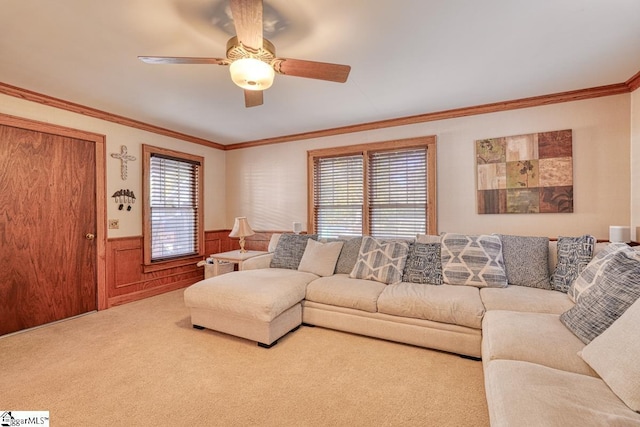 living room with carpet floors, crown molding, wooden walls, and ceiling fan