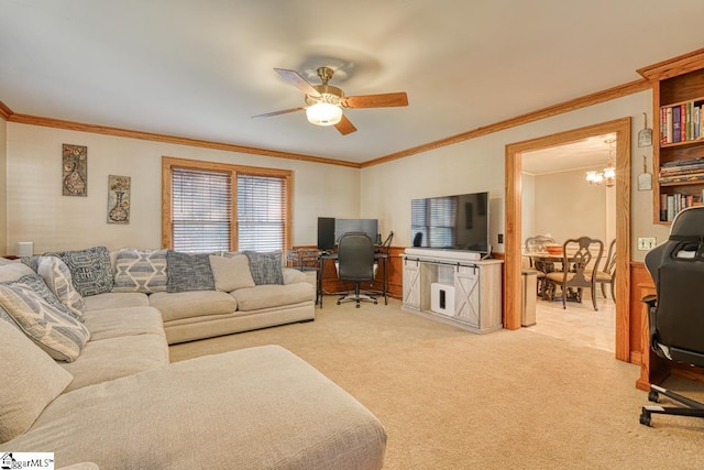 living room with carpet flooring, ceiling fan with notable chandelier, and ornamental molding