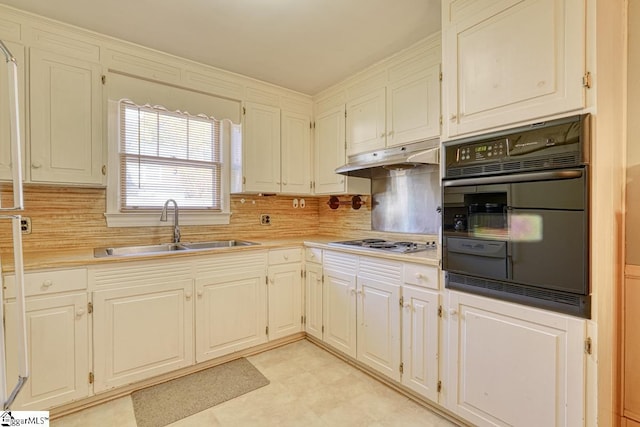 kitchen with decorative backsplash, oven, stainless steel gas cooktop, and sink