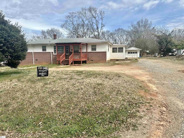 single story home with a deck, dirt driveway, crawl space, a chimney, and a front yard