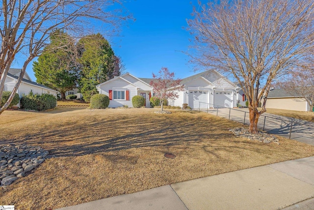 ranch-style home featuring a garage and a front lawn