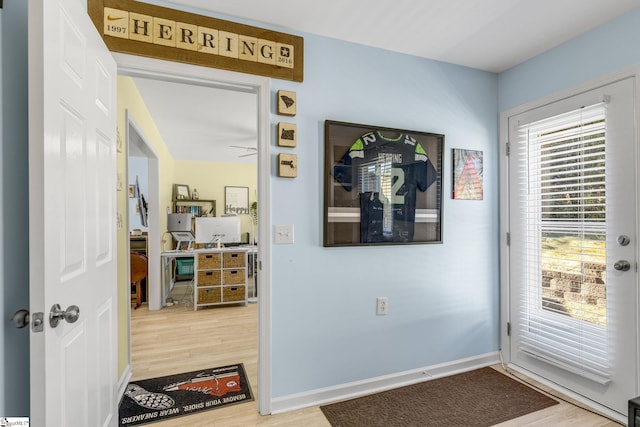 doorway to outside with hardwood / wood-style floors and ceiling fan