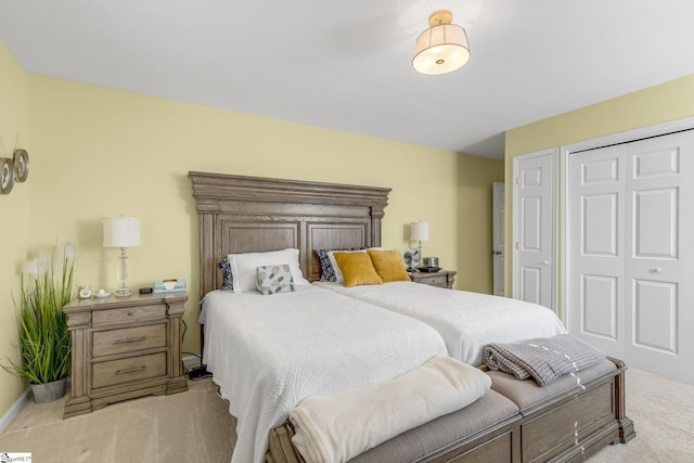 bedroom with light carpet and a closet