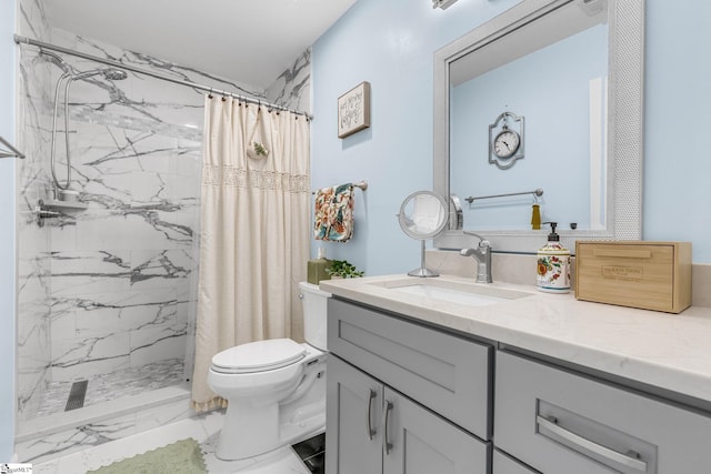 bathroom with curtained shower, vanity, and toilet