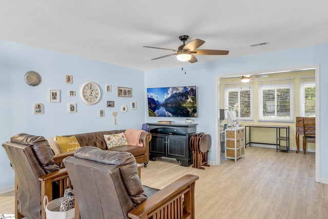 living room featuring ceiling fan and light wood-type flooring