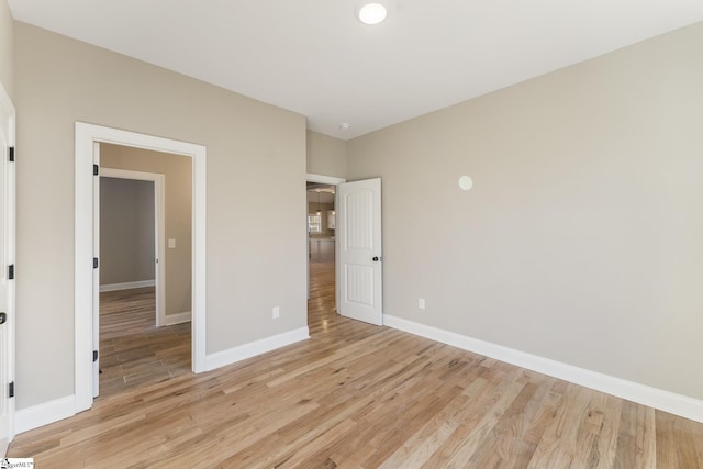 unfurnished bedroom featuring baseboards and light wood-style floors